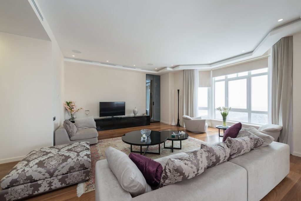 interior-of-spacious-living-room-with-comfy-sofas-and-parquet-floor-7534553 Bright and cozy living room featuring modern furniture and elegant decor.